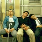 MEN ASLEEP ON A TRAIN TOKYO JAPAN